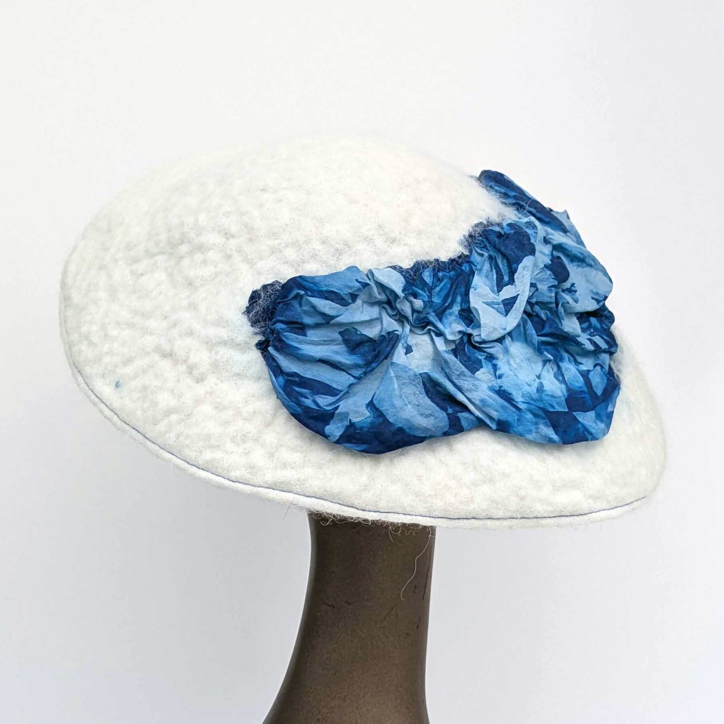 White felted saucer hat with cyanotype printed blue ruched fabric - back view