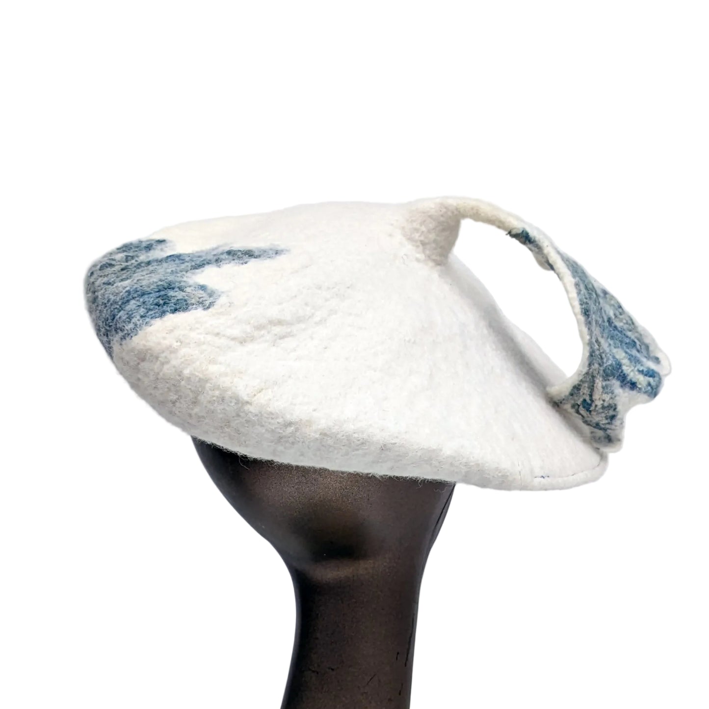 Back view of beret with blue-green leafy tassel -worn by mannequin.