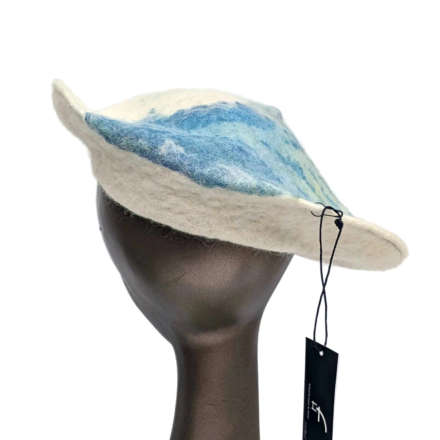 Cream coloured saucer beret hat with blue seaweed Cyanotype print on the tip - worn by a mannequin. Back view