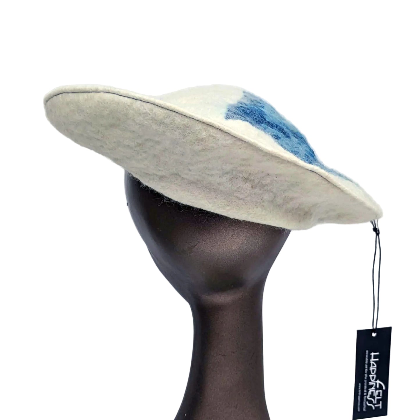 White beret with blue seaweed pattern on tipof hat - worn on mannequin - back view