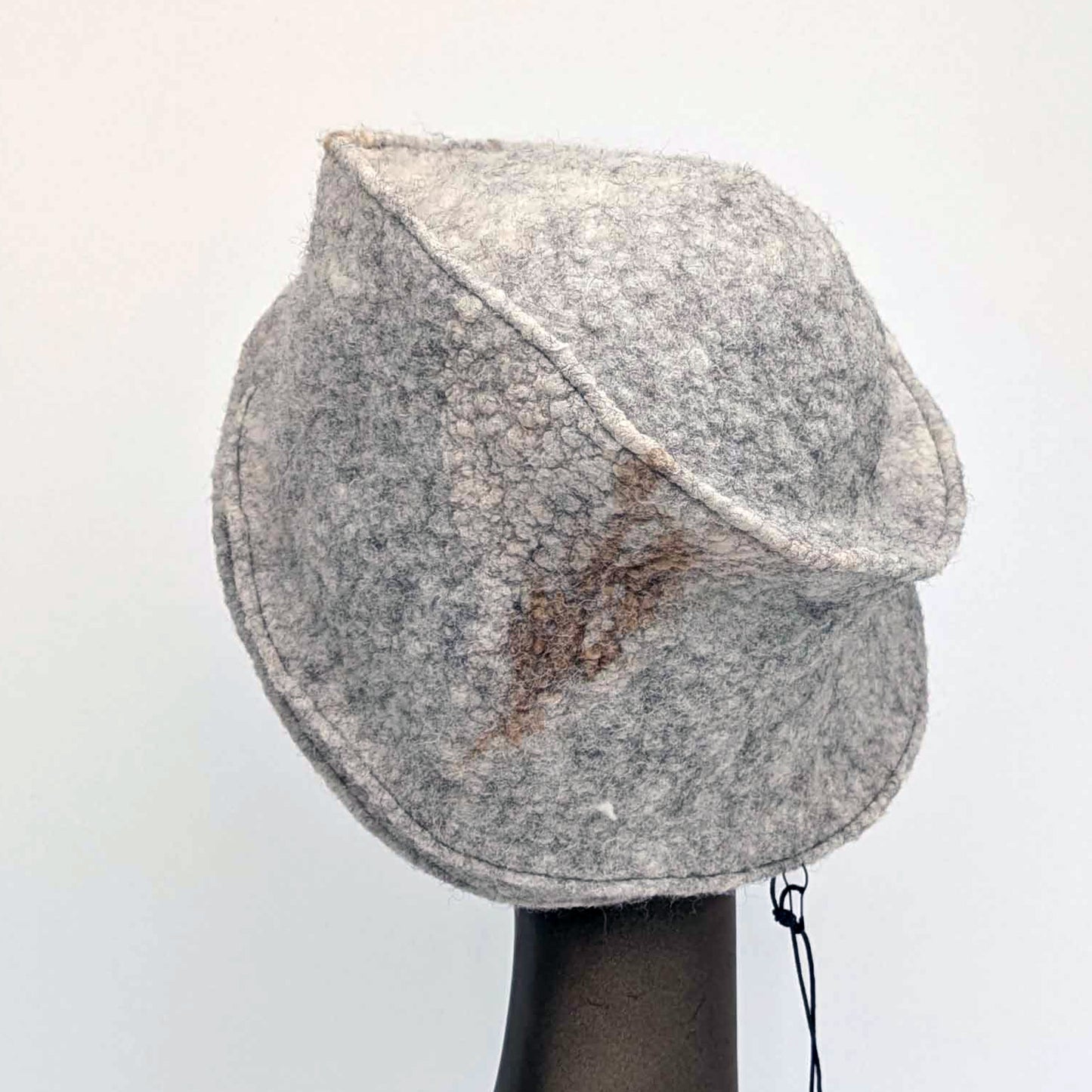 Grey cloche hat on a mannequin head against a white background - back view.