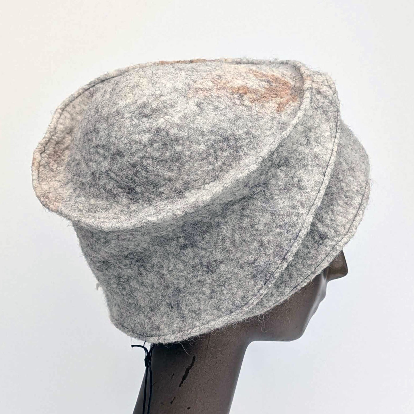 Grey bucket hat on a mannequin head against a white background - side view.