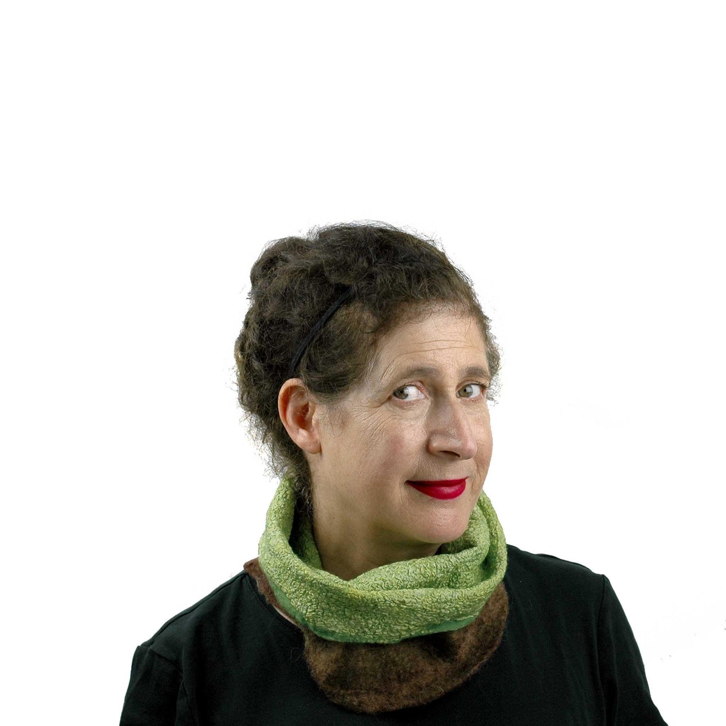 Felted Kiwi Neck Cowl worn folded down so green colored silk side shows.