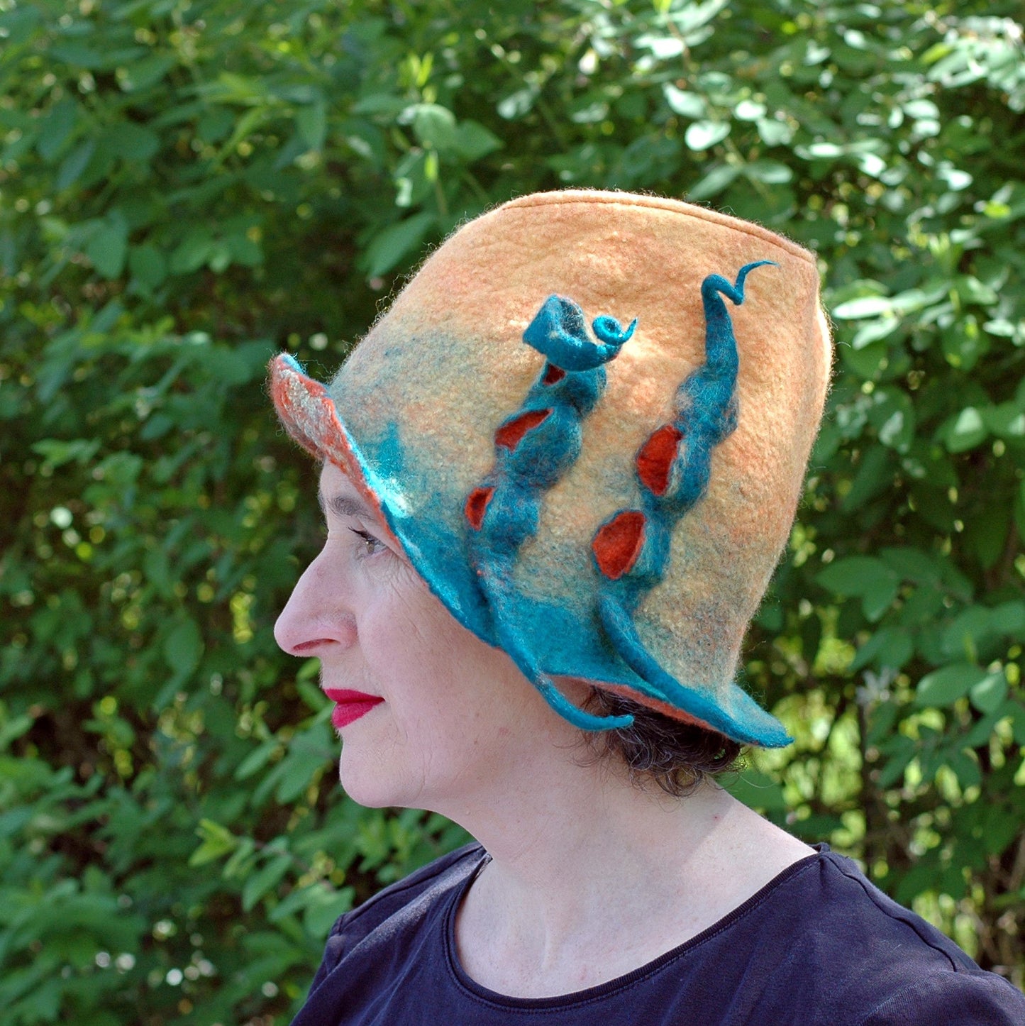 Yellow Fedora with Green Peapods - side view against shrubbery