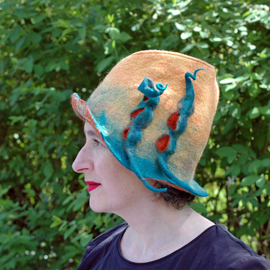 Yellow Fedora with Green Peapods - side view against shrubbery