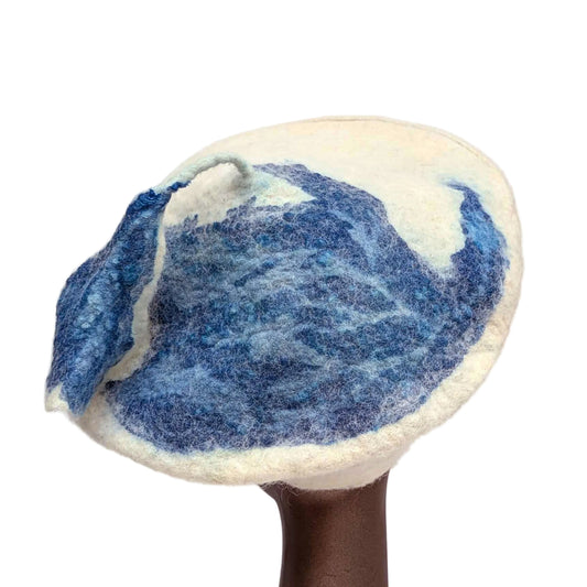 Organic blue bird-shaped print on creamy white beret - with blue tassel stem.