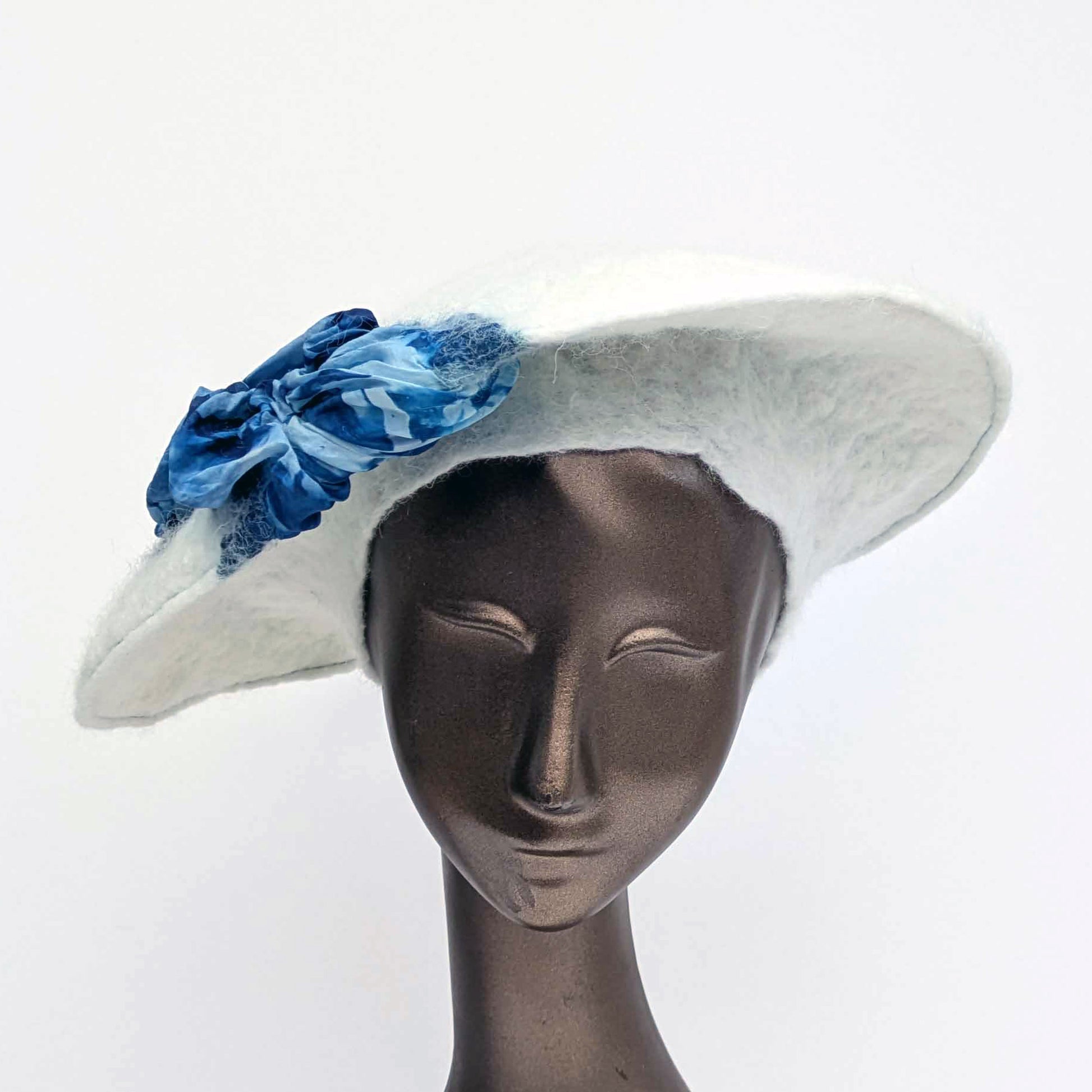 White felted saucer hat with cyanotype printed blue ruched fabric - front view