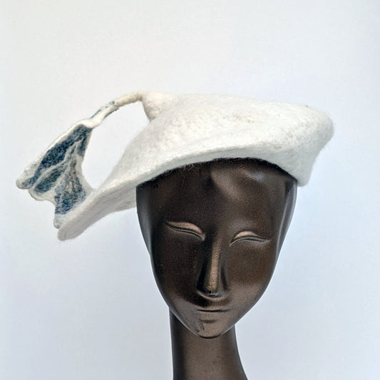 White beret with blue-green silk 'seaweed' leaf stem.