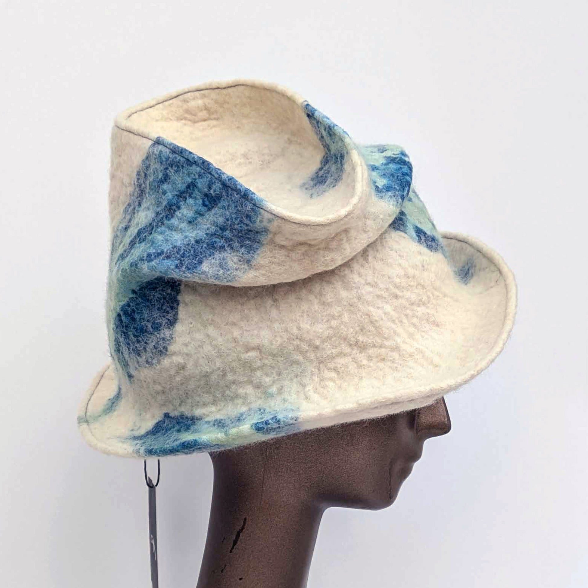 "Crushed' tip, Fedora hat with blue and green pattern on a mannequin head against a white background
