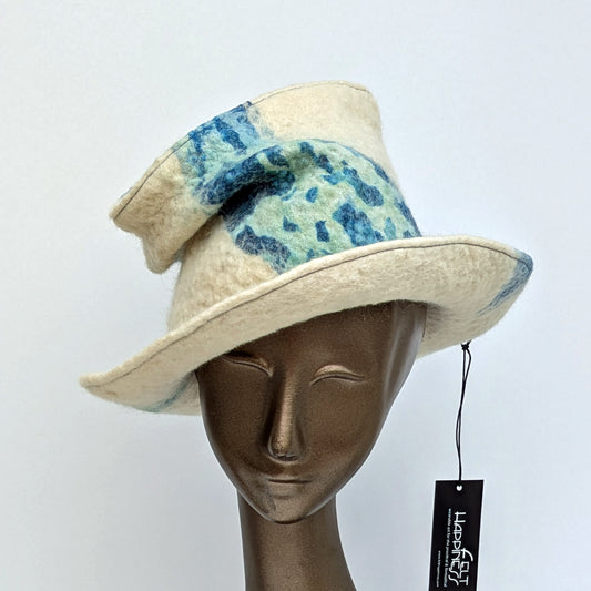 Wide brimmed cream coloured hat with crushed tip.