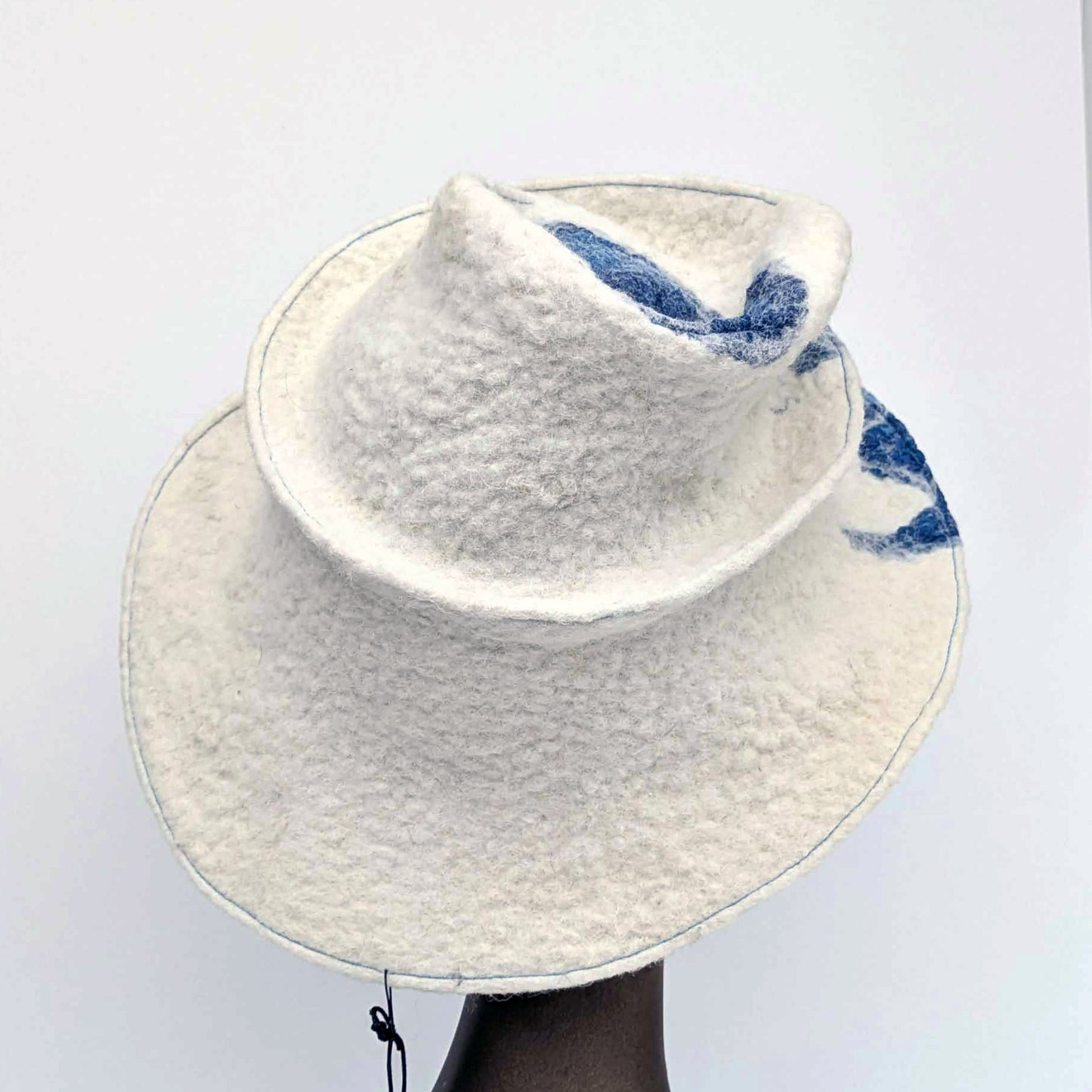 Wide brimmed, cream coloured hat with blue seaweed printed fabric - back view