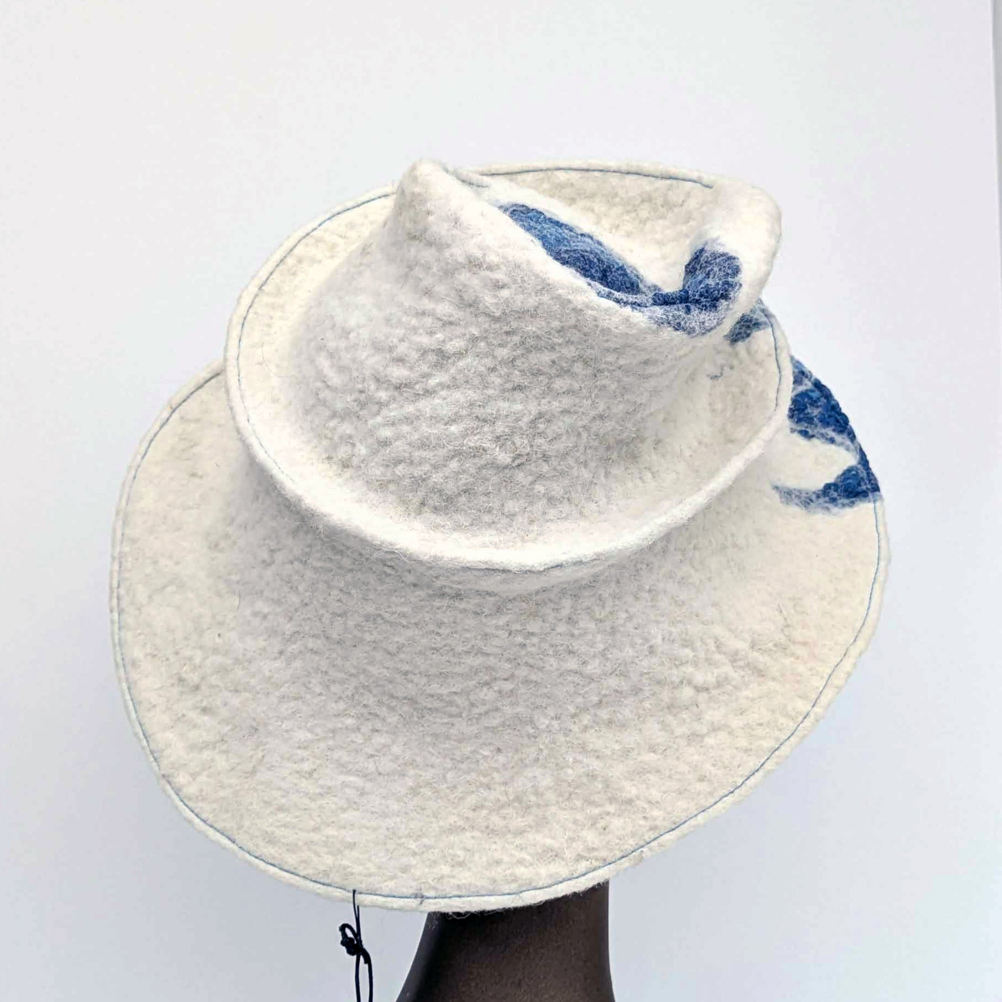 Wide brimmed, cream coloured hat with blue seaweed printed fabric - back view