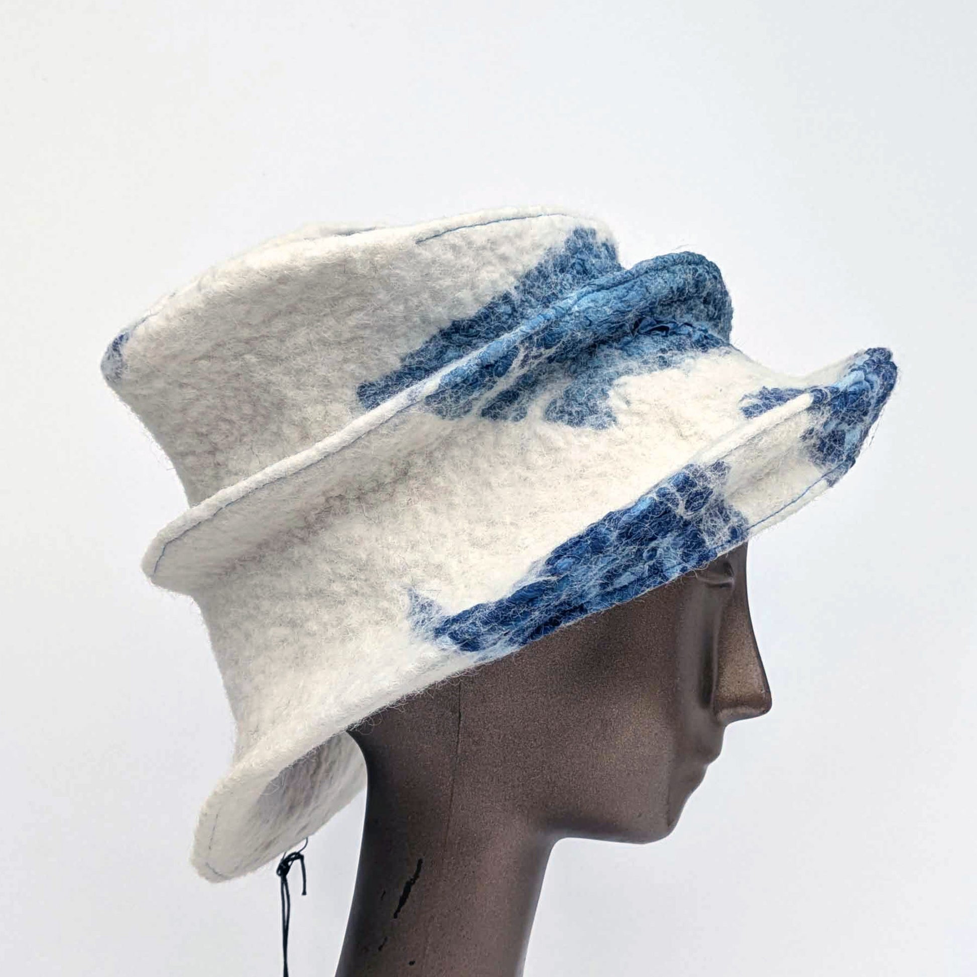 Wide brimmed, cream coloured hat with blue seaweed printed fabric - side view