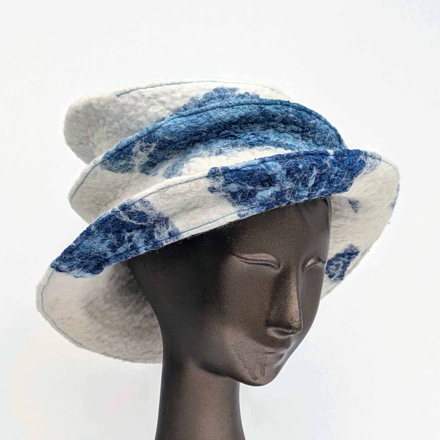 Wide brimmed, cream coloured hat with blue seaweed printed fabric - threequarters view