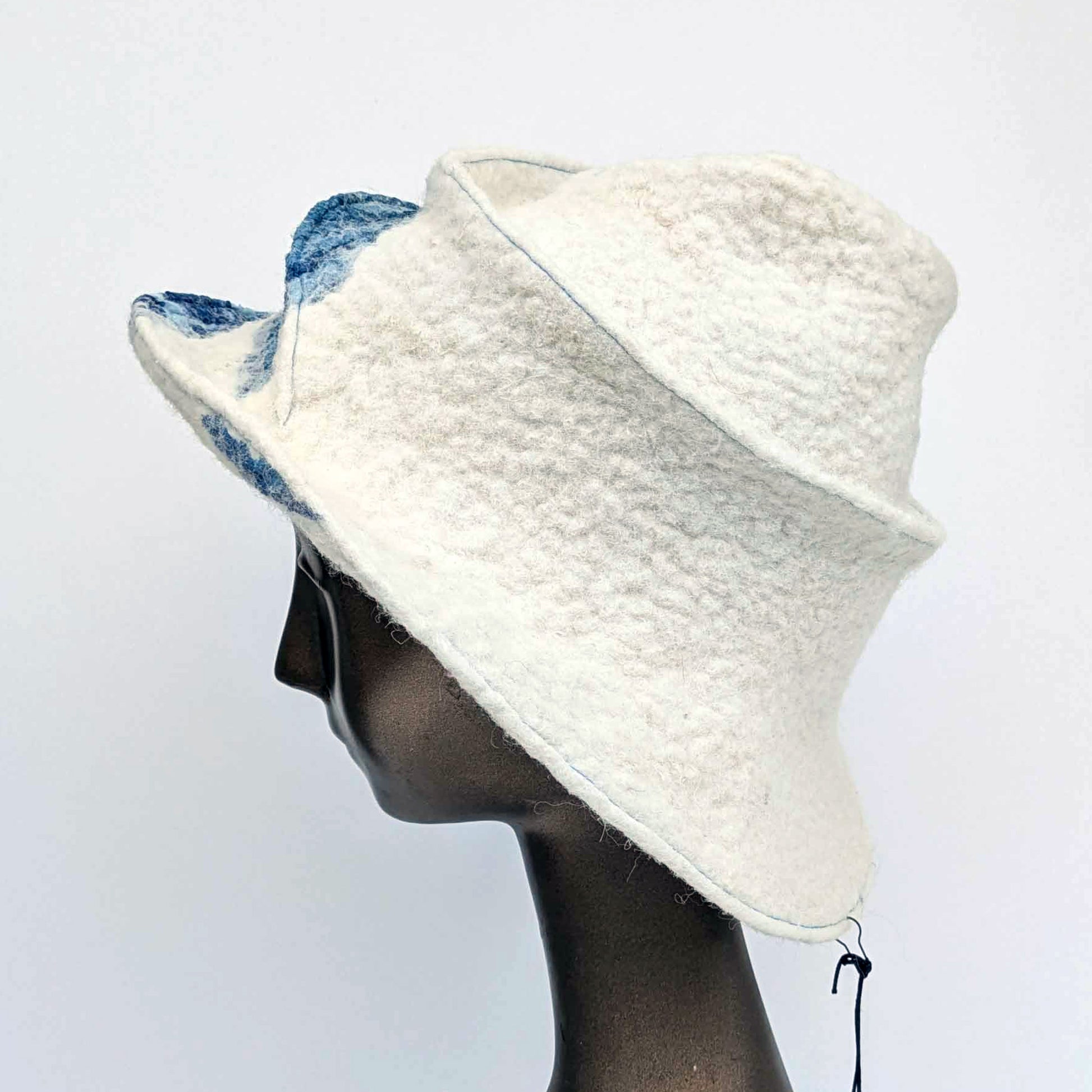 Wide brimmed, cream coloured hat with blue seaweed printed fabric - side view
