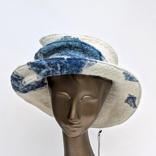 Wide brimmed, cream-coloured hat with indigo-blue silk felted in - worn on mannequin
