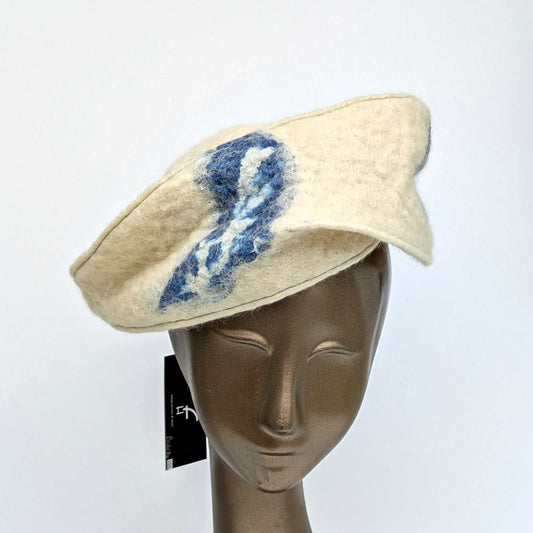 Angled cocktail hat in creamy white, that has a rakish brim that resembles that of a Greek fisherman's cap.
