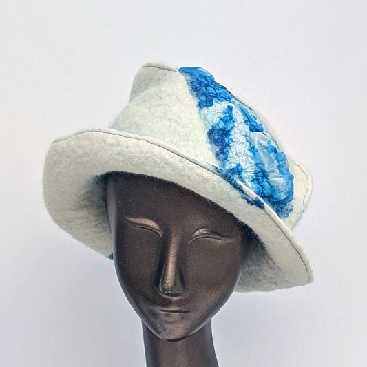 White hat with blue seaweed pattern on a mannequin head against a white background