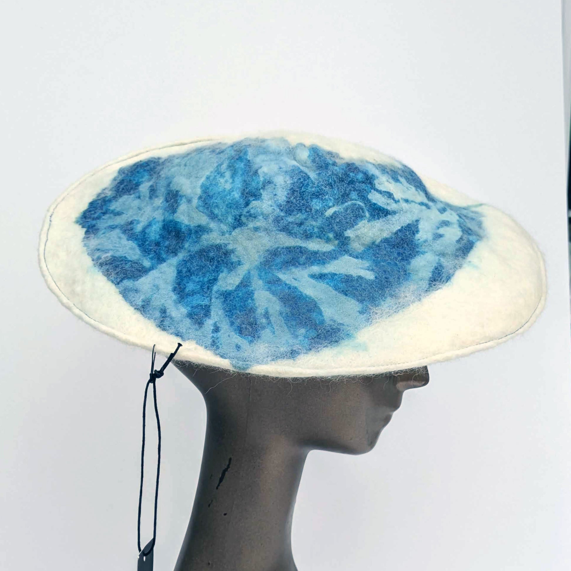 White beret with blue seaweed pattern on mannequin -side view