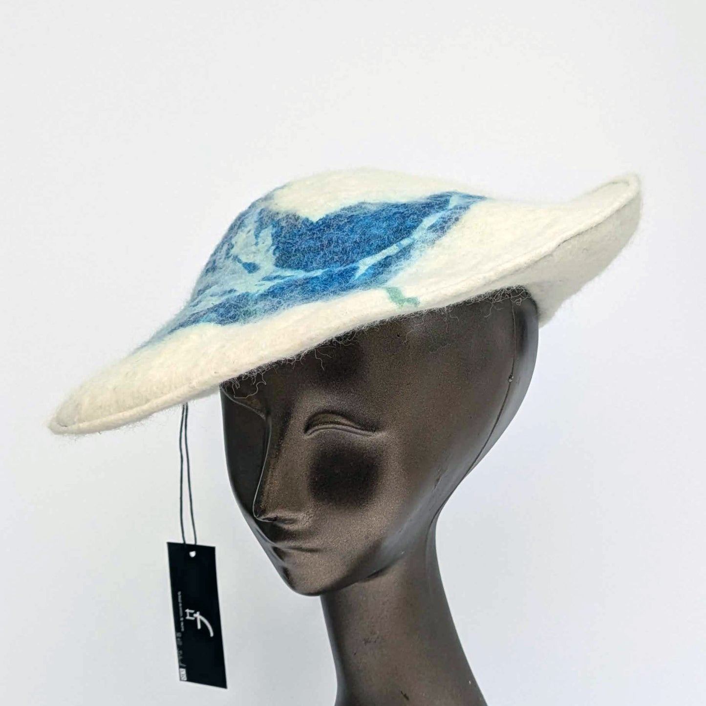 White beret with blue seaweed pattern on mannequin - threequarters view
