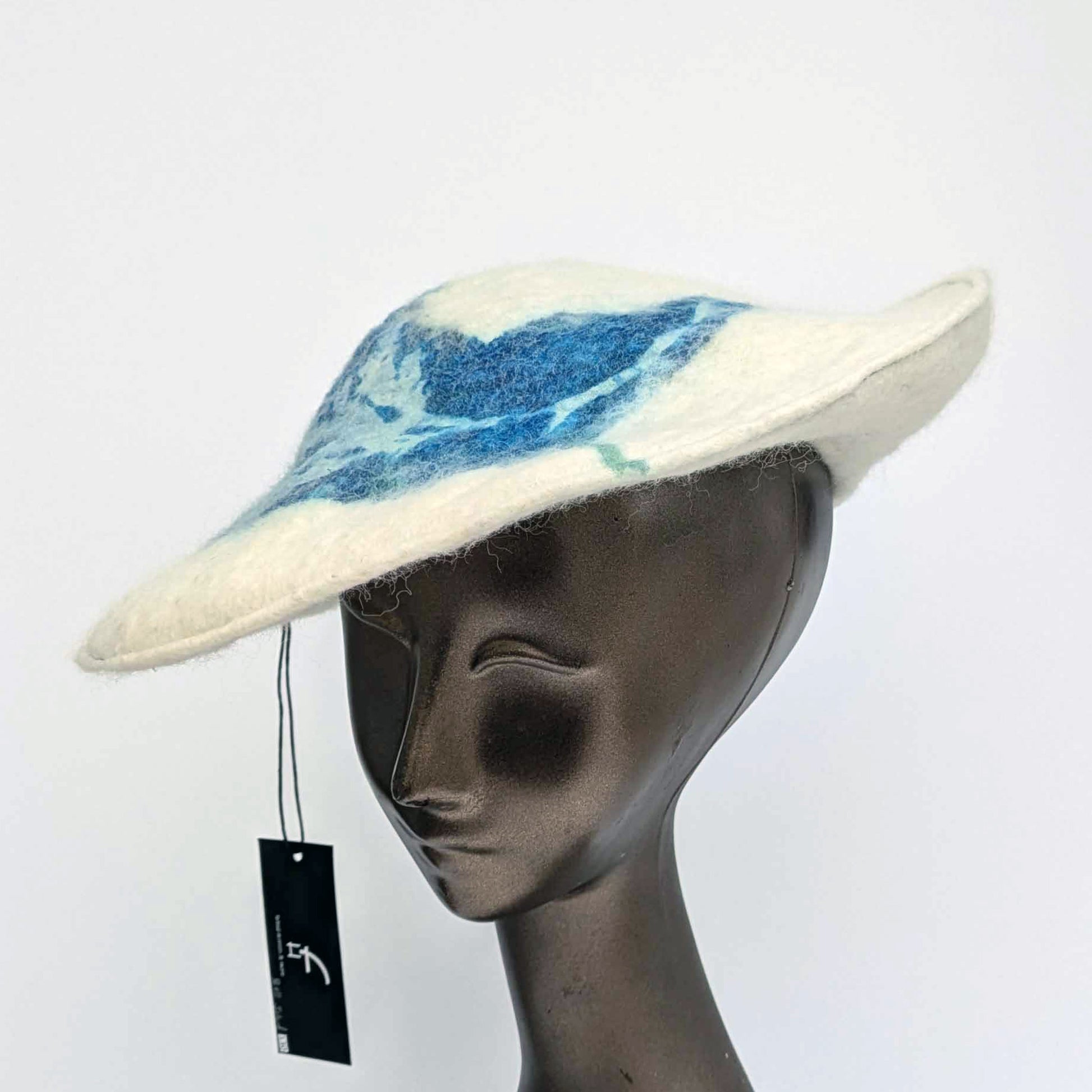 White beret with blue seaweed pattern on mannequin - threequarters view
