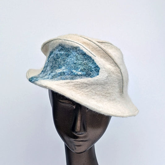 Hat with narrow brim like a Trilby style of Fedora, in creamy white with nunofelted blue-green Cyanotype-printed silk.