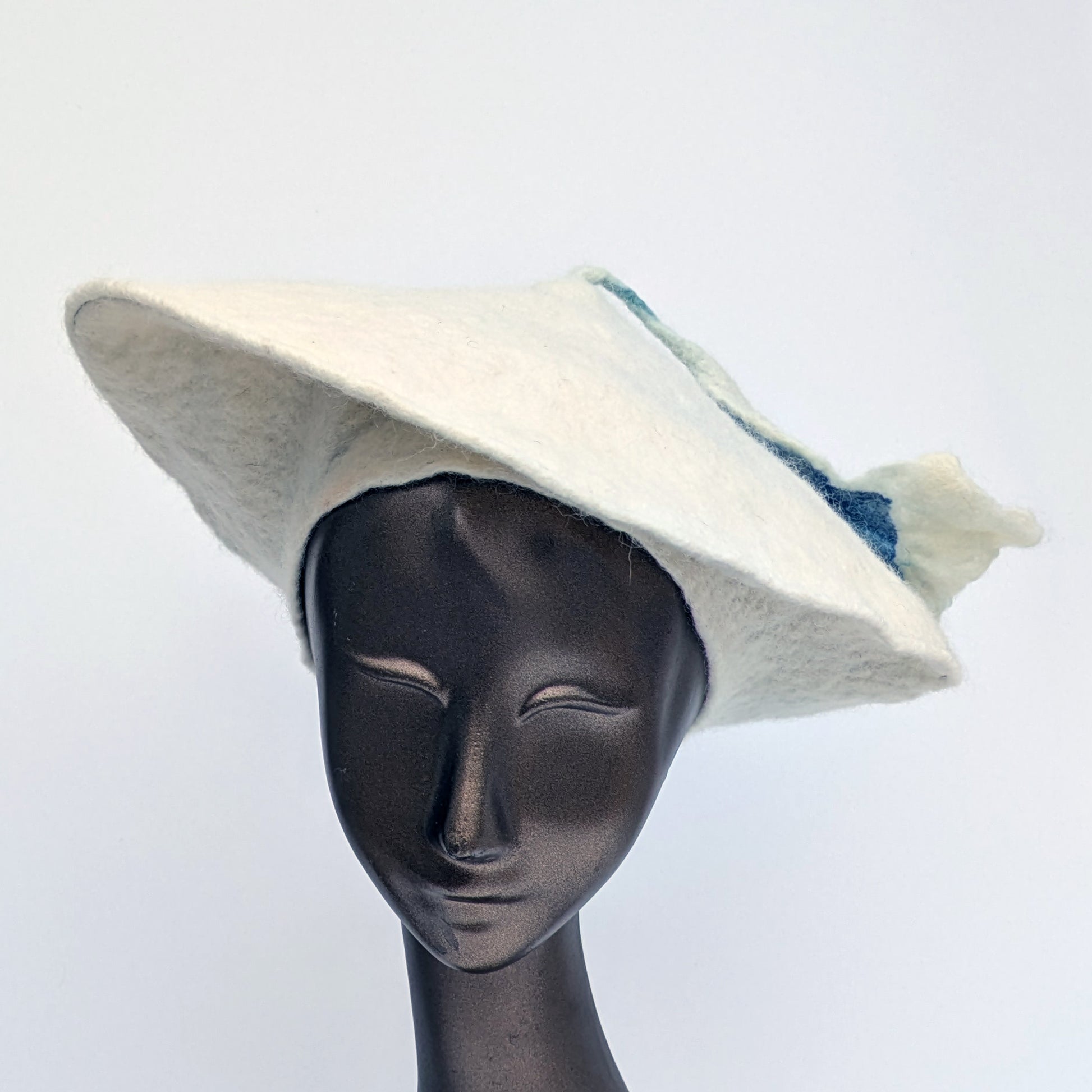 White felted beret with a blue and white tassel - front view
