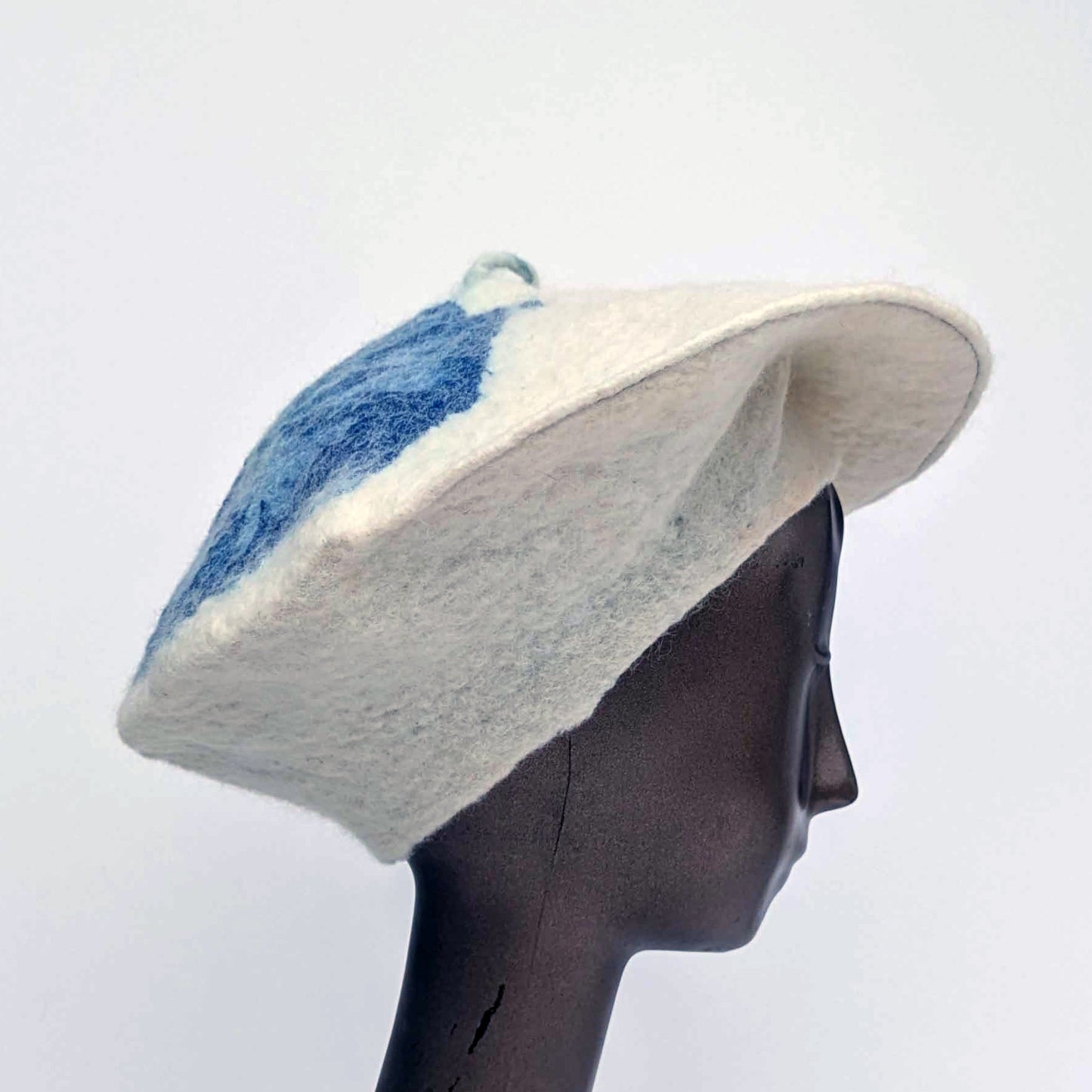 White beret with blue cyanotype printed seaweed on top - worn by mannequin