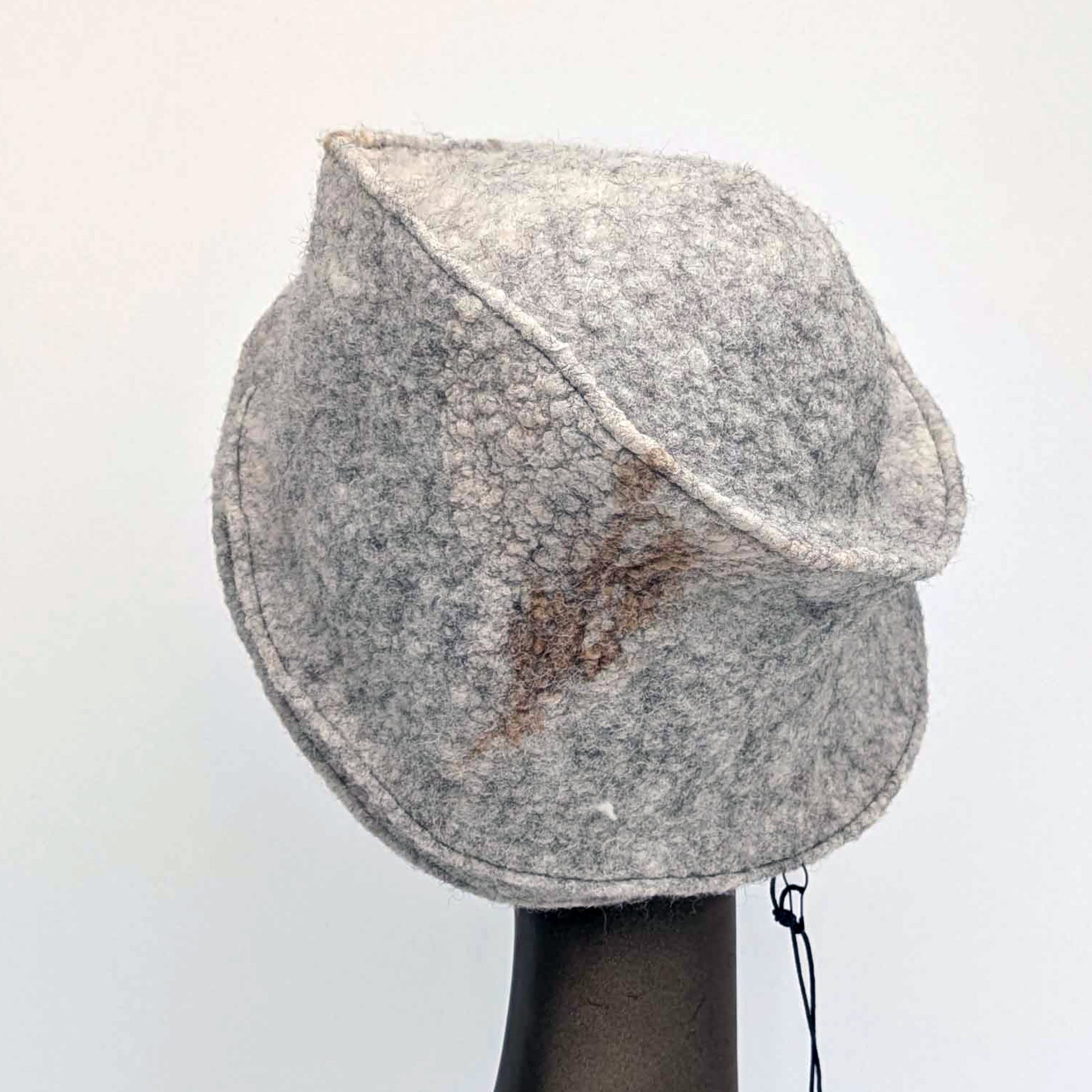 Grey cloche hat on a mannequin head against a white background - back view.