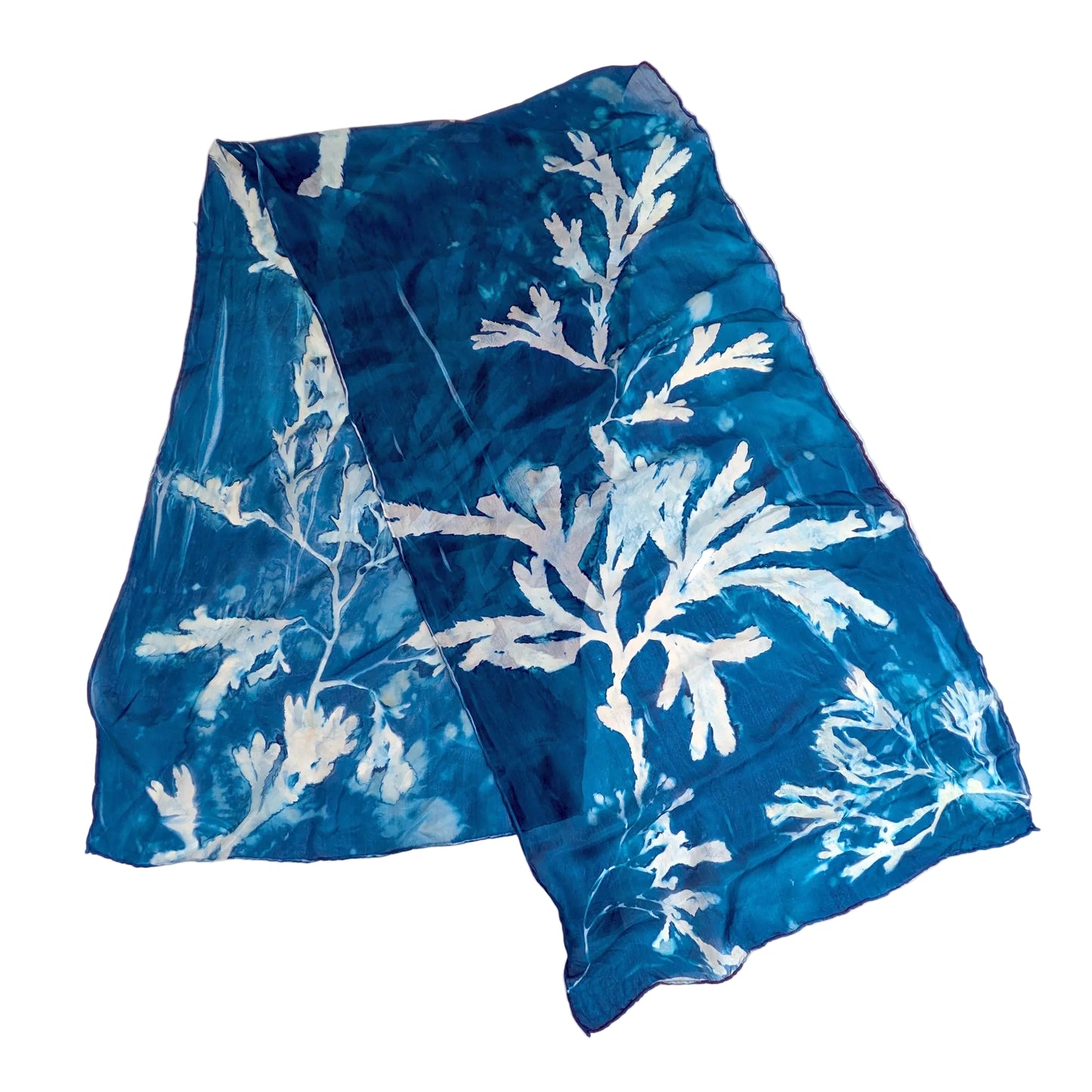 Blue fabric with white seaweed leaf pattern on a white background