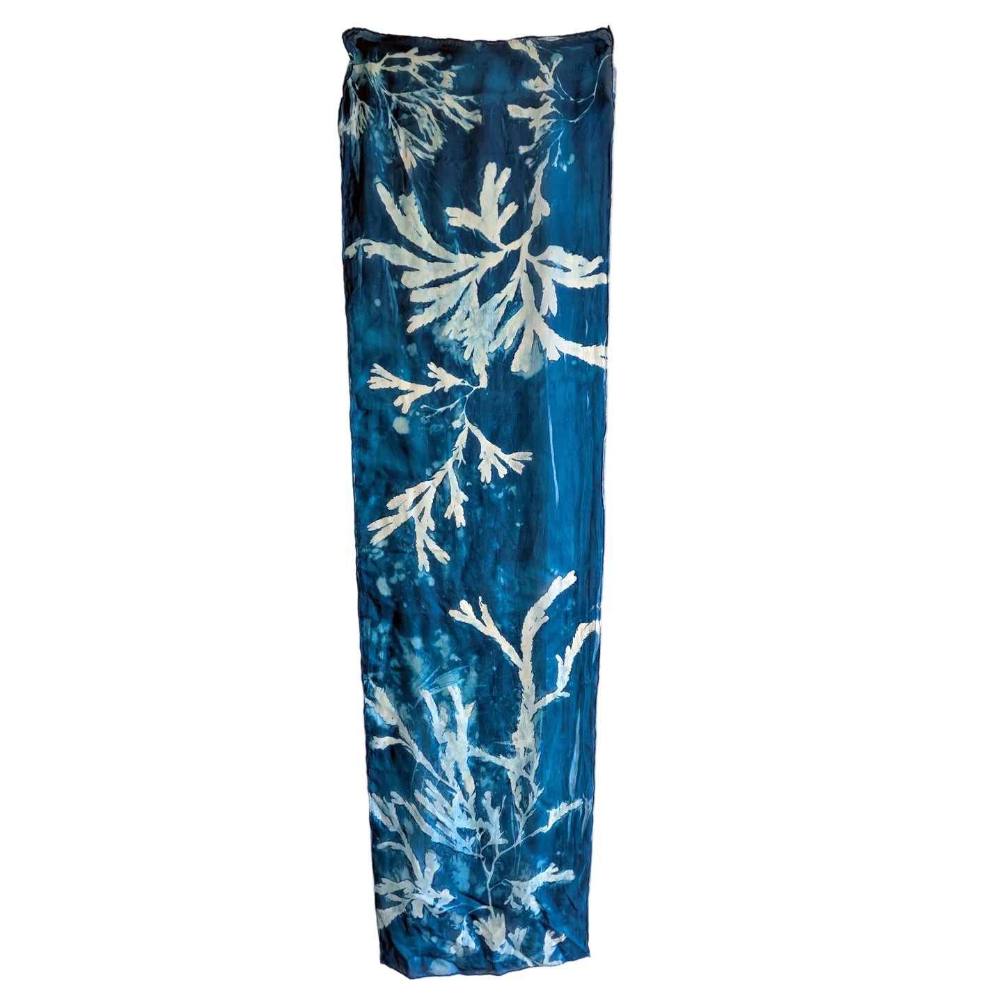 Blue rectangular scarf with white leaf pattern on a white background