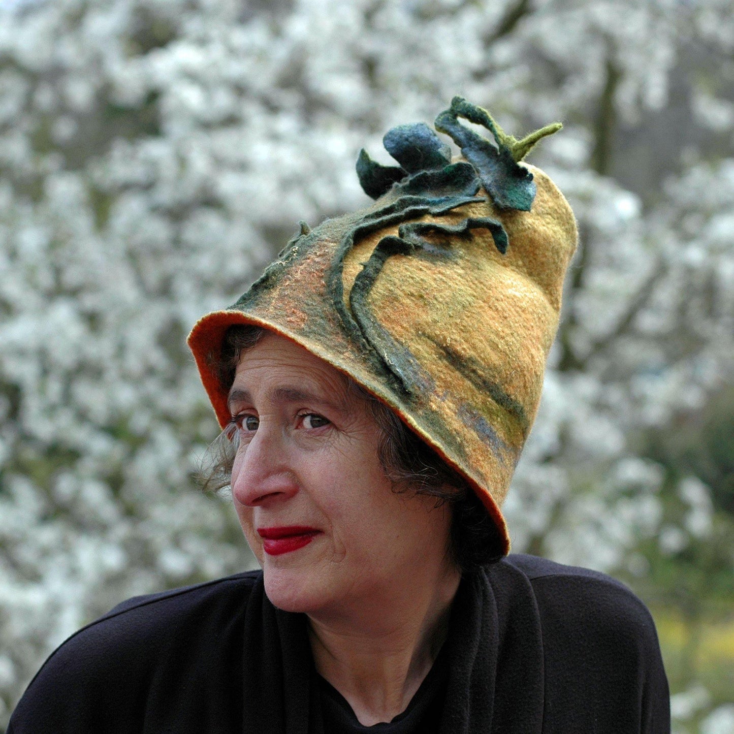 Big Tree Inspired Felted Hat - in front of blossoms