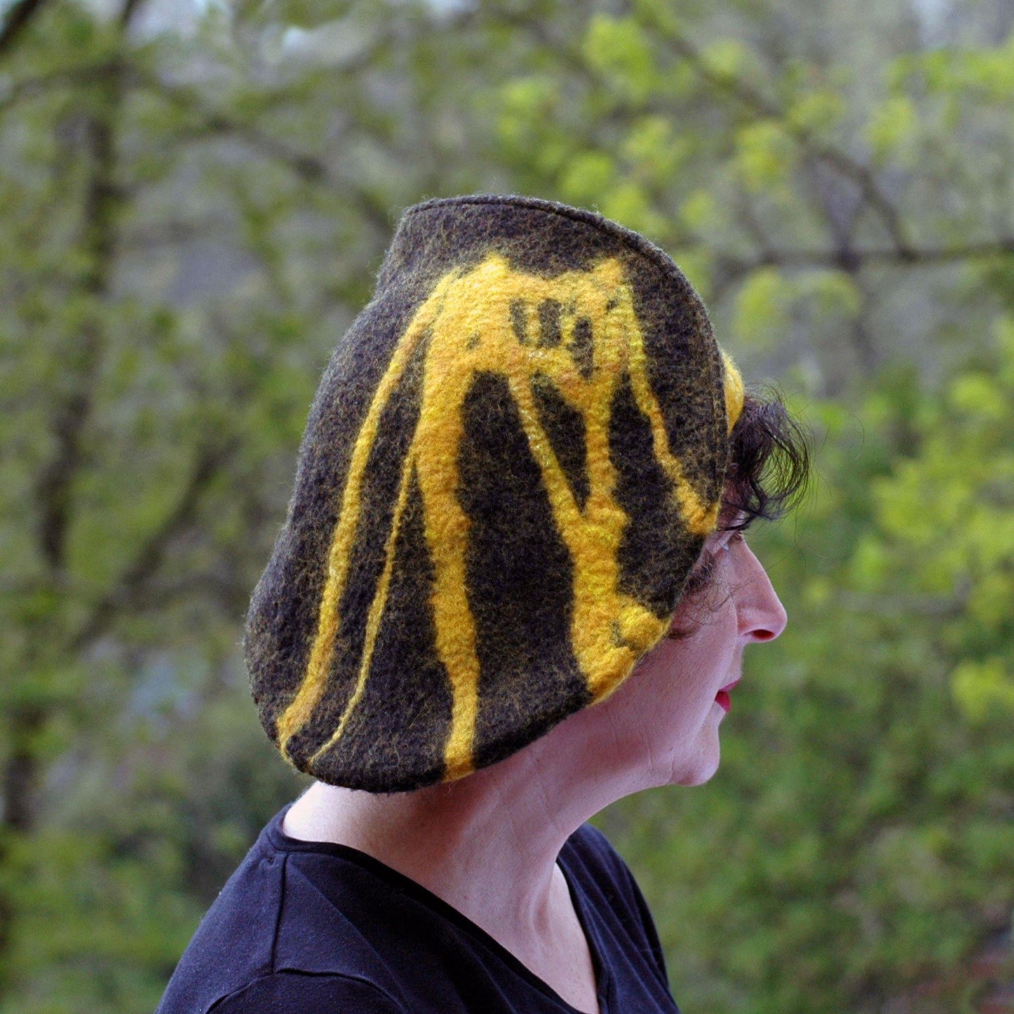 Black and Gold Beret with Bridge - with greenery behind