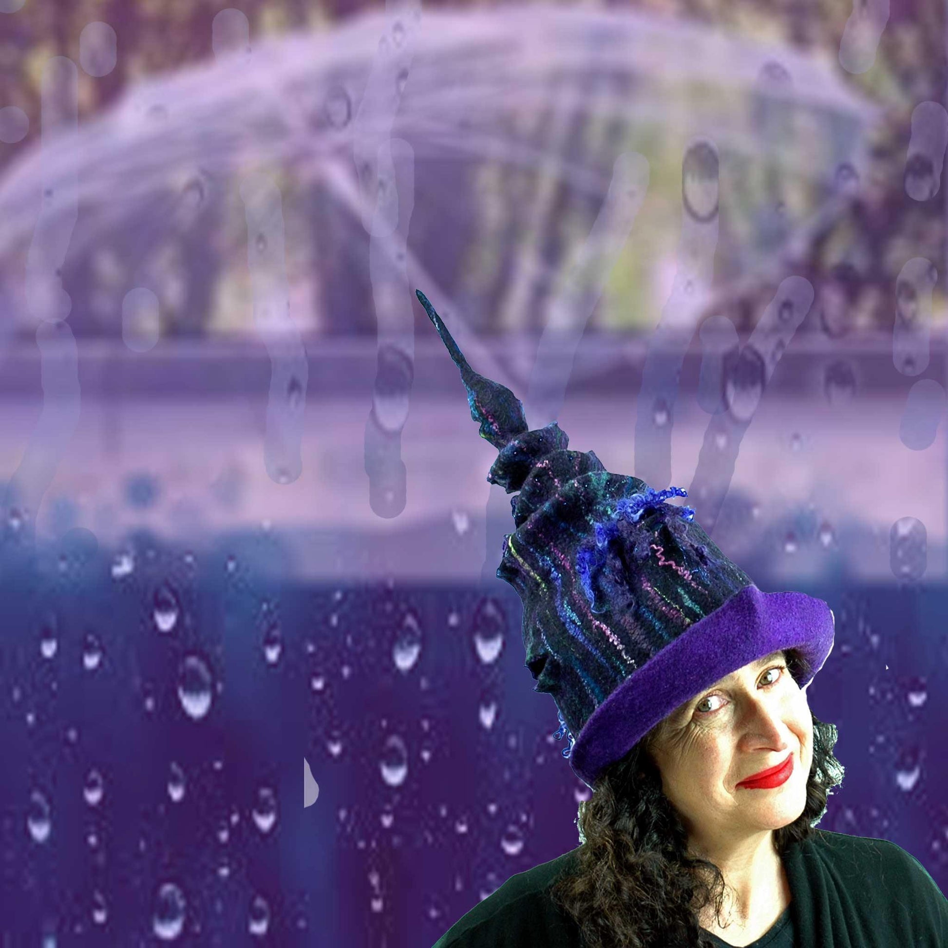 Dark Unicorn Felted Wizard Hat against a background of purple rain and an umbrella.