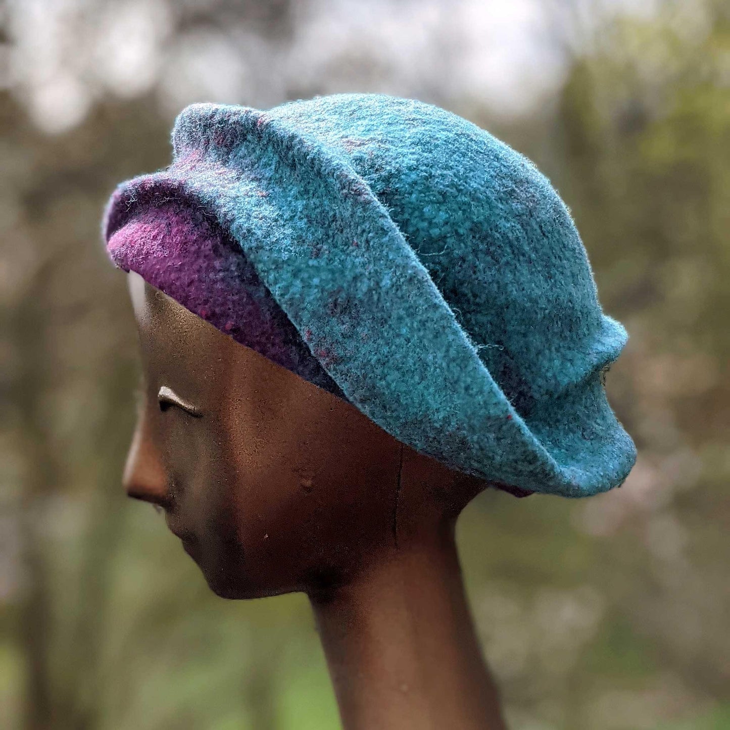 Undulating Spiral Hat in Blue-Green and Raspberry - side view
