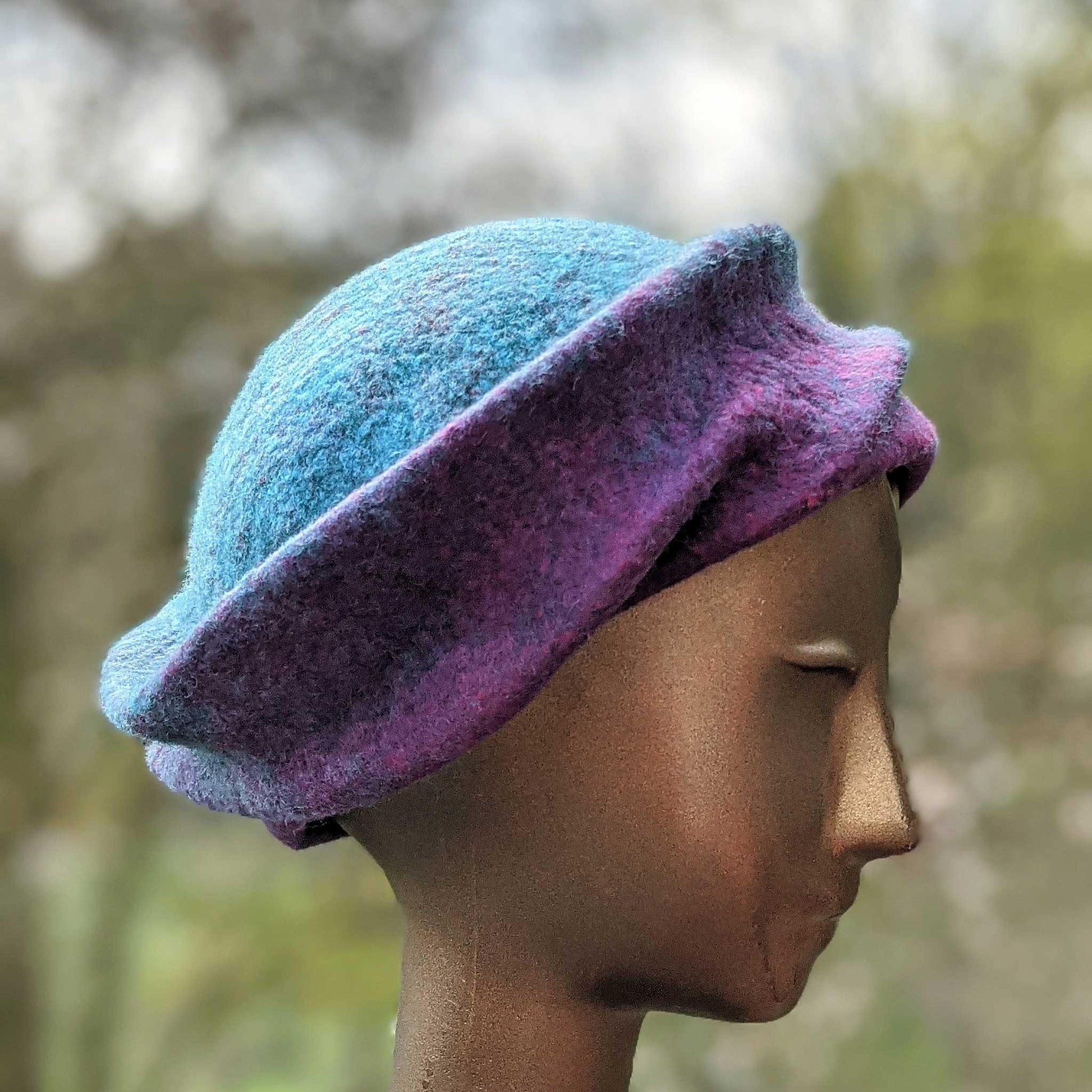 Undulating Spiral Hat in Blue-Green and Raspberry - side view