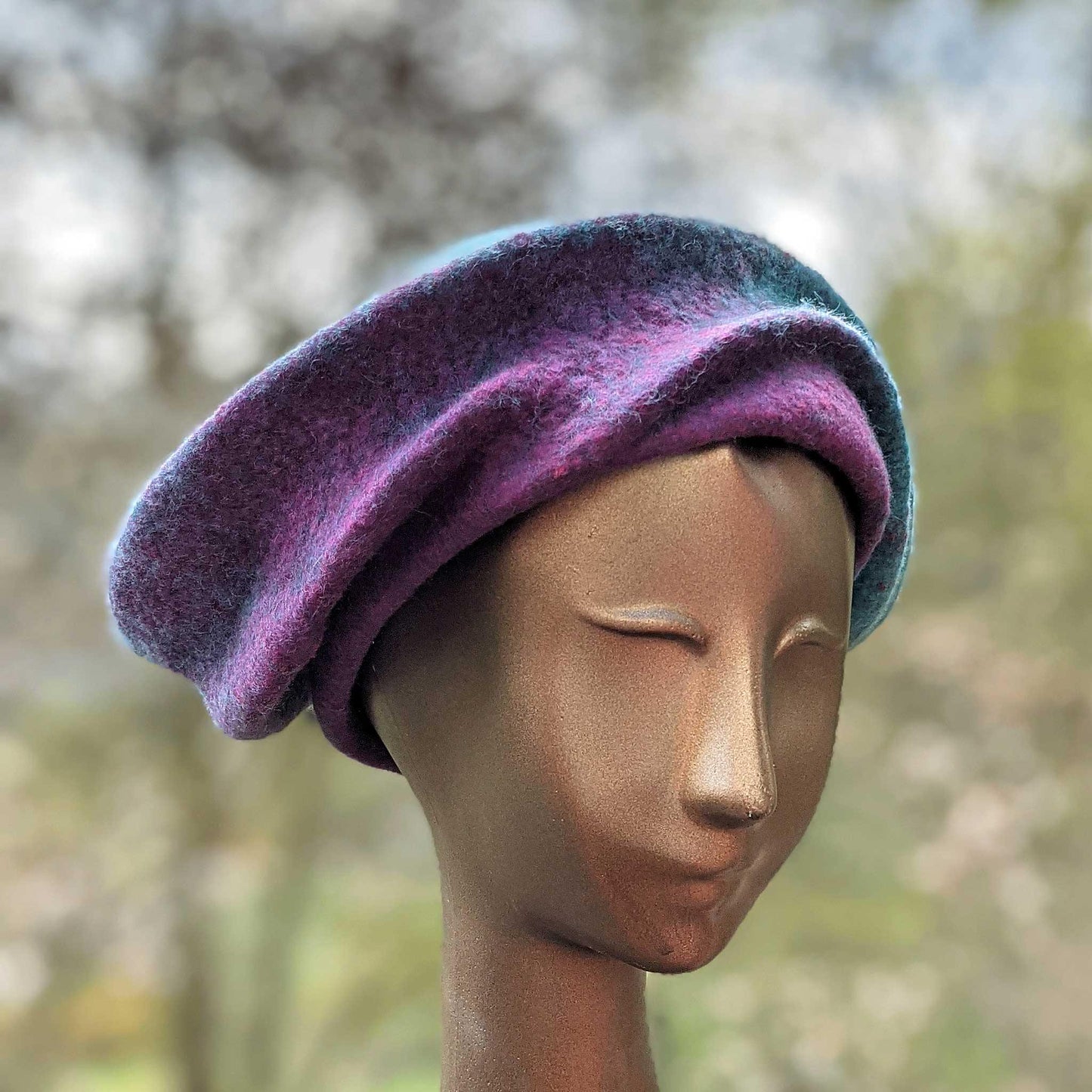 Undulating Spiral Hat in Blue-Green and Raspberry - threequarters view